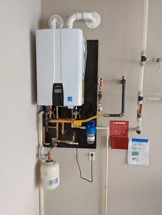 Professional plumber installing copper piping in a Ilchester home